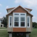 Platinum Cottages front box bay with two windows on the sides and a shingle-style accent in the center