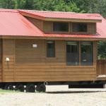 Platinum Cabin with lap siding in mahogany stain and a red metal roof