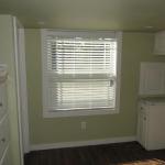 Green wall and ceiling with white trim and cabinets